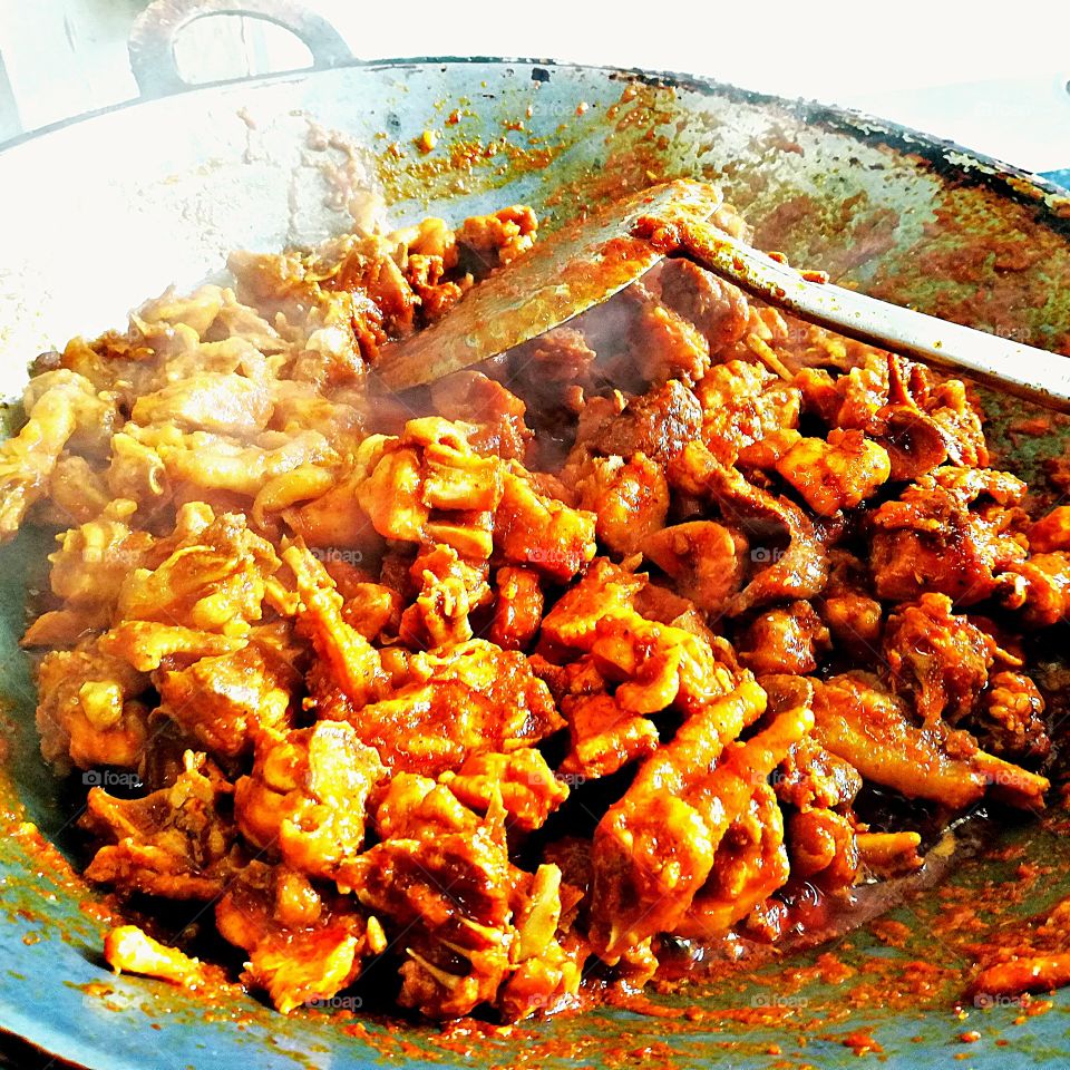 Stir fried chicken and curry paste. Thai food cooking by Thai people.