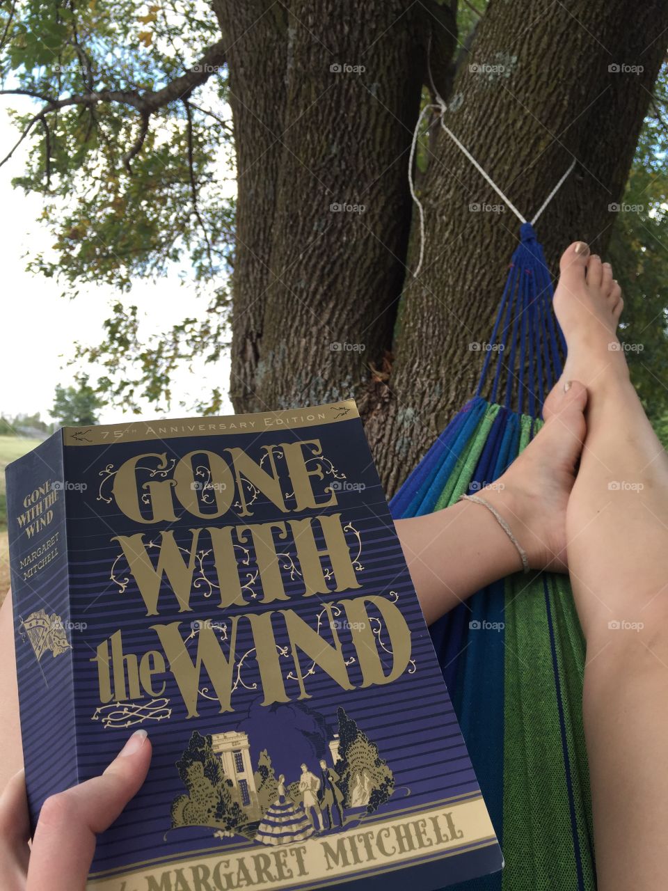 Reading Gone with the Wind in a hammock 