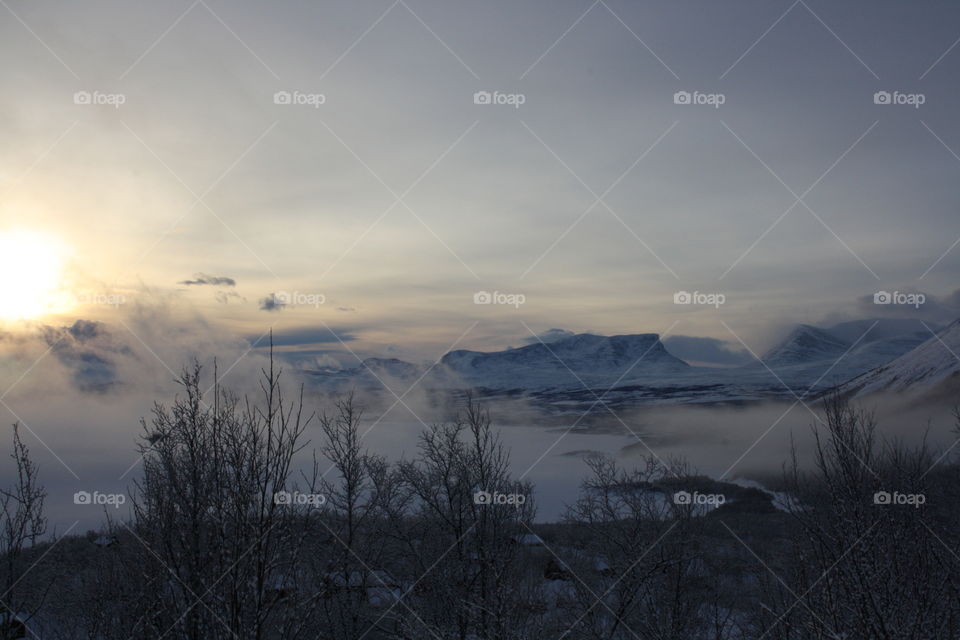 Frozen lake in foggy weather