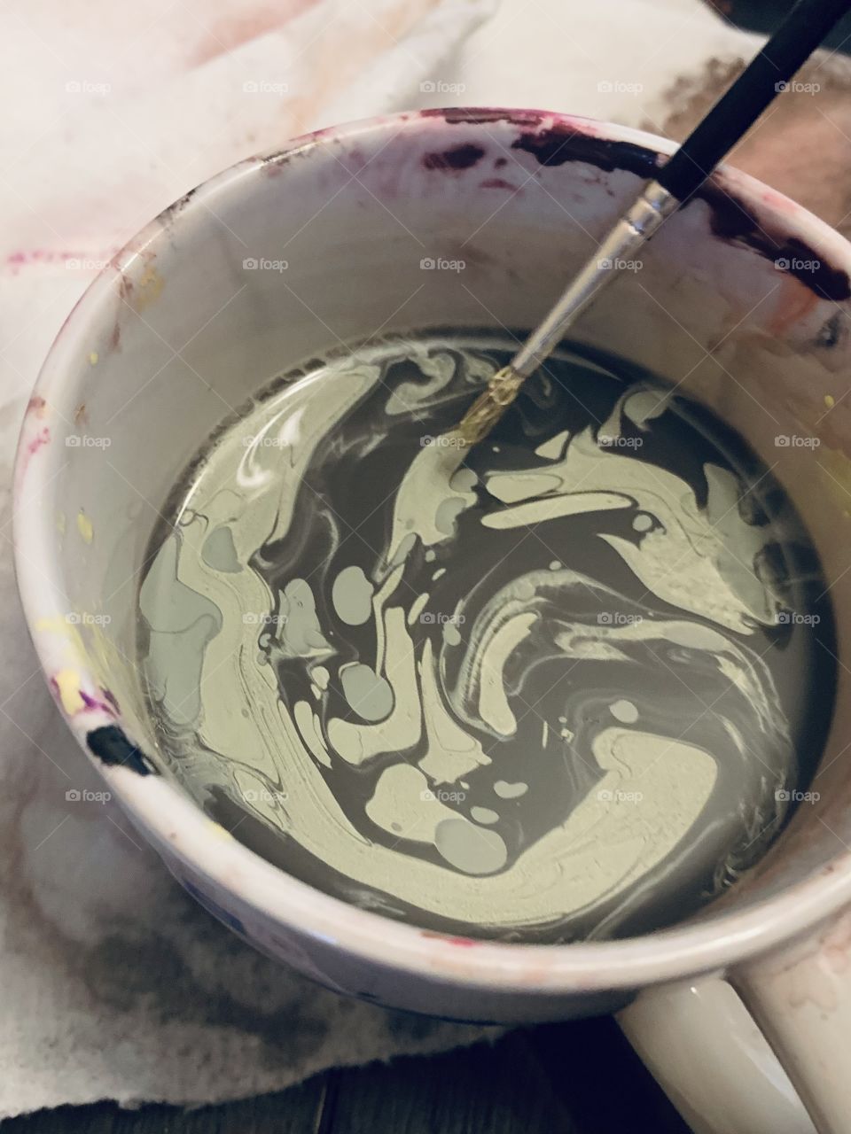 Mixing different colors of paints making a swirl pattern 