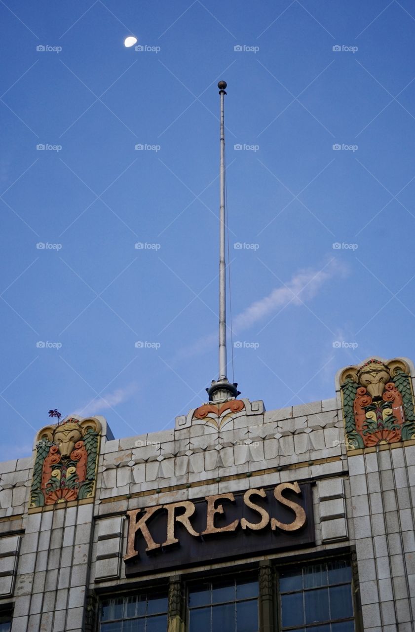 Old Kress department store building with great ornate detail in fascia with moon and vapor trails.