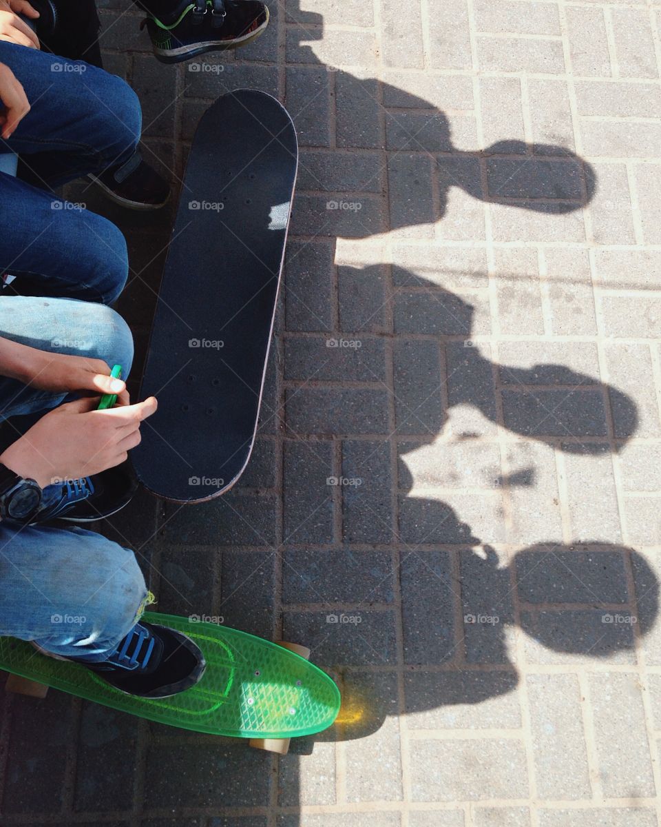 Children with skates sit on a bench