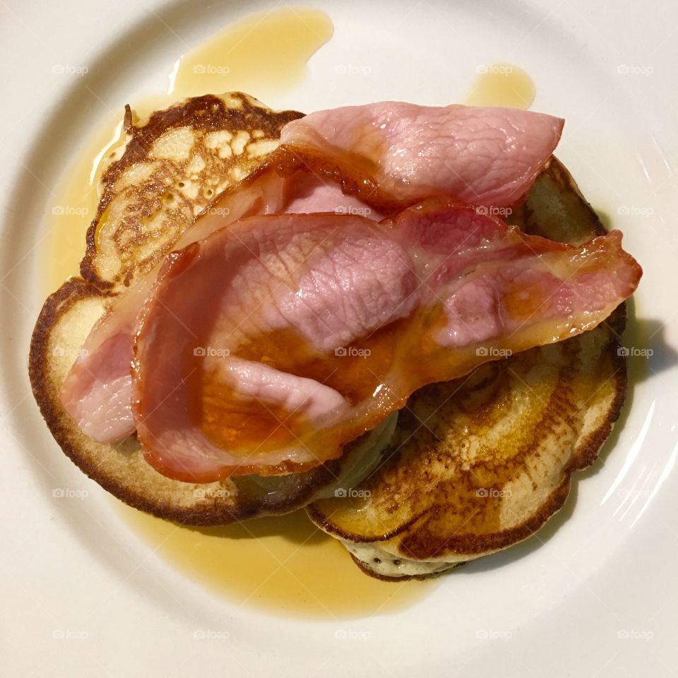 Homemade American pancakes with bacon and maple syrup