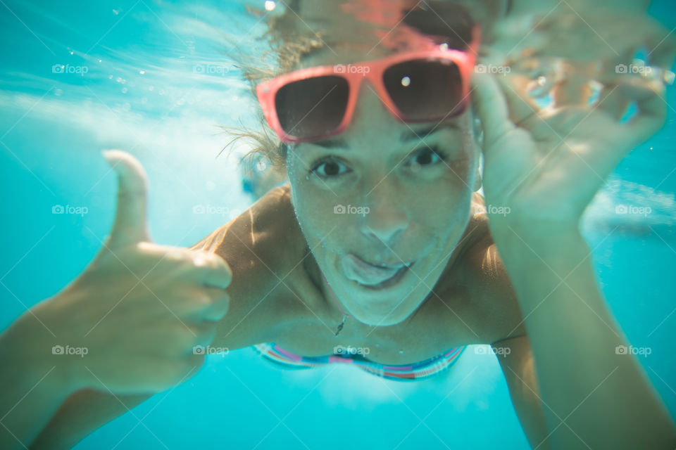 beautiful girl underwater.  girl is happy and glad to swim underwater.  emotions, joy, happiness