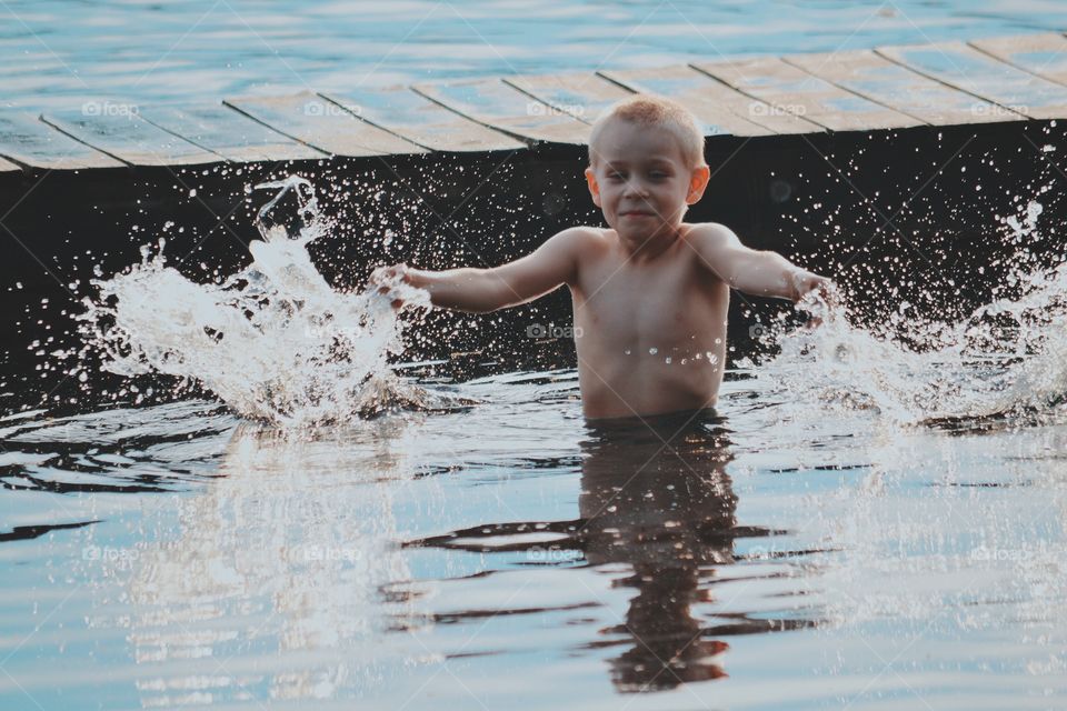 Boy bathing in the lake