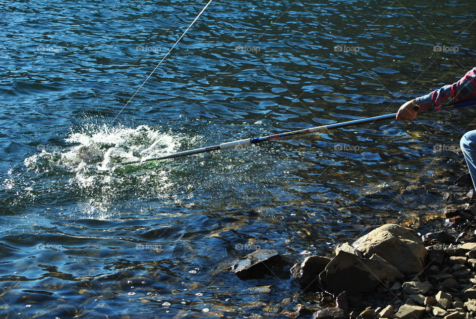 Catching a fish by the lake