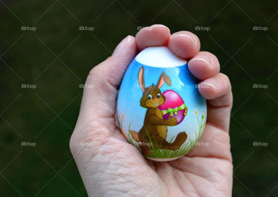 Easter egg in the hand spring holiday