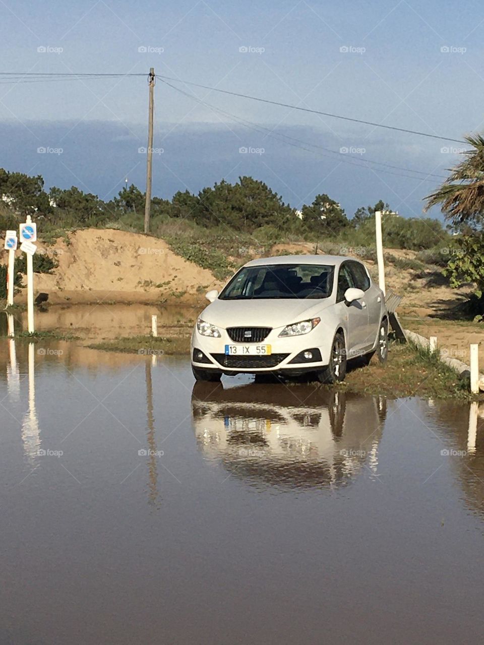 parked car trapped in the rain