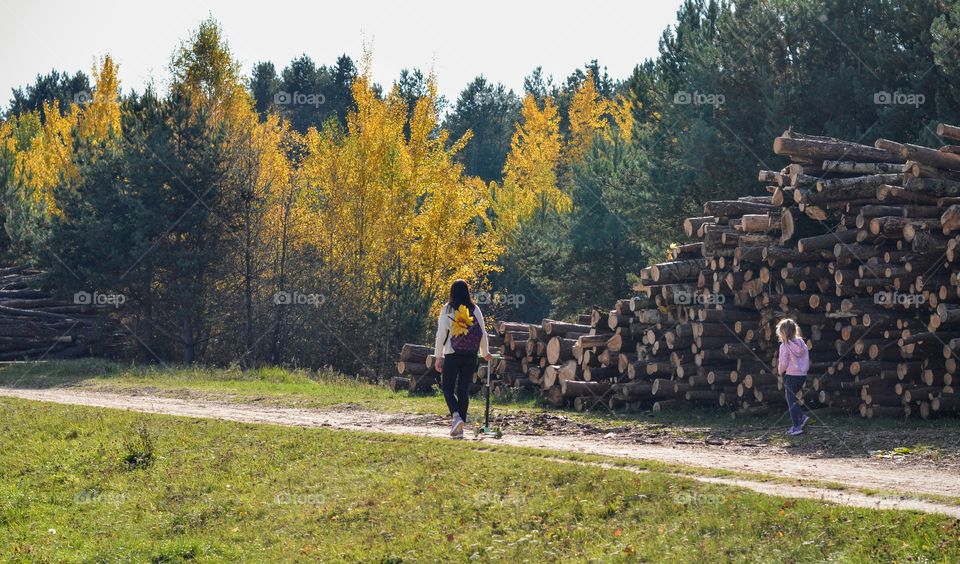 family mother and daughter walking outdoor autumn landscape