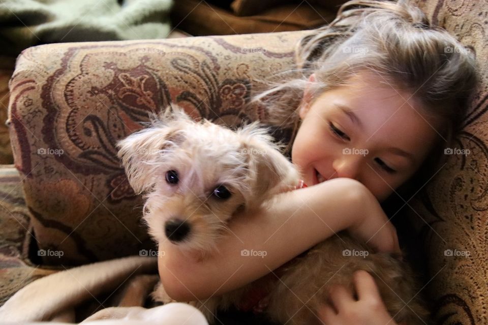 Happy Little girl holding new pet 