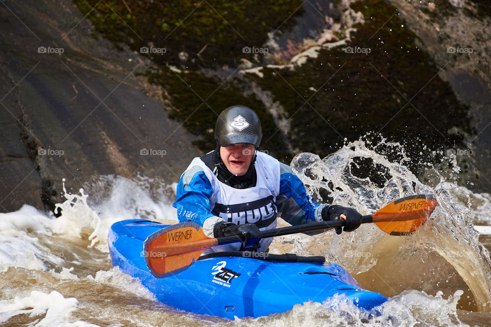 Helsinki, Finland -  April 15, 2018: Unidentified racer at the annual Icebreak 2018 whitewater kayaking competition at the Vanhankaupunginkoski rapids in Helsinki, Finland.