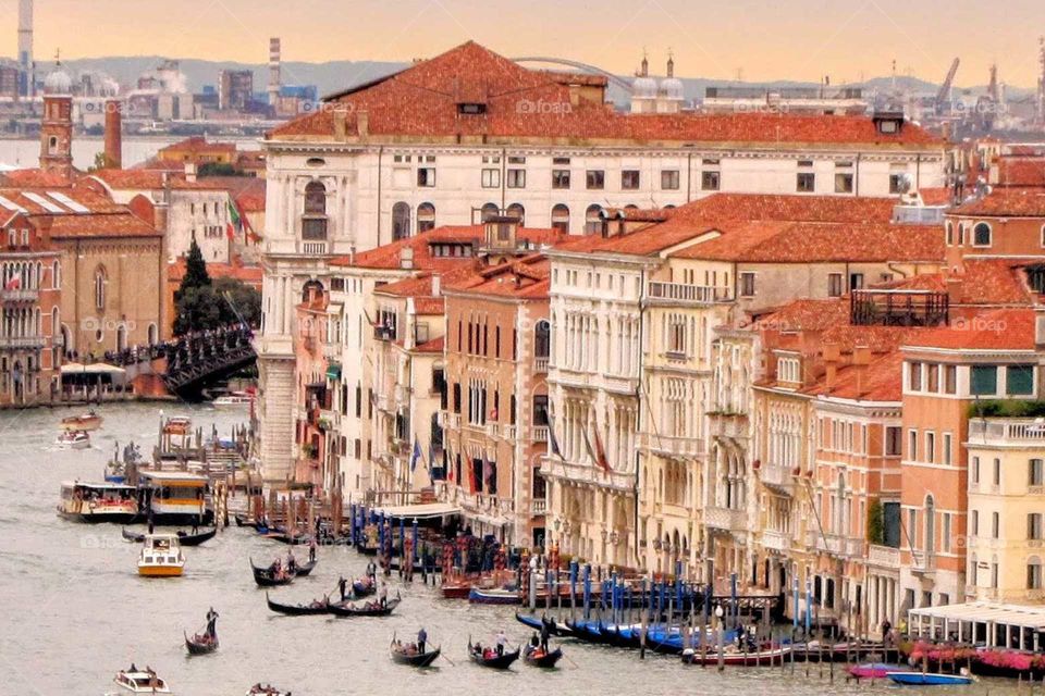 a view of Venice, Italy showing multi-story buildings and gondolas on a rainy September afternoon