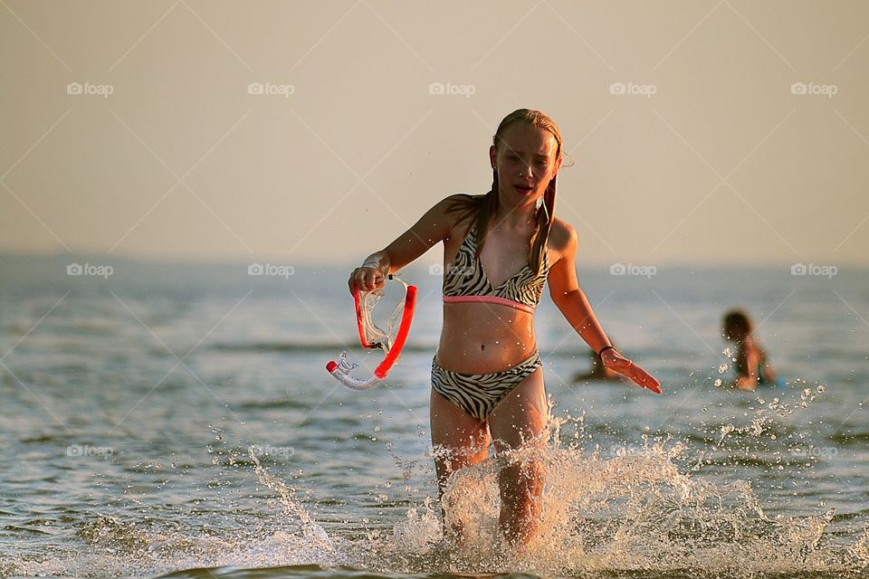 Running. A girl running towards the beach