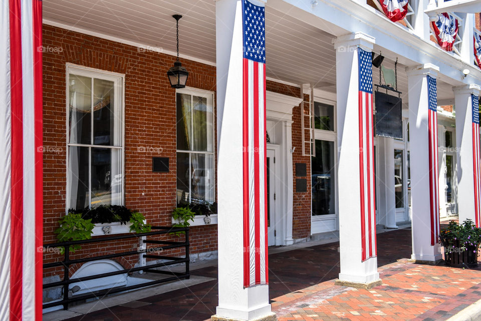 Historical building with long hanging American flags on its pillars