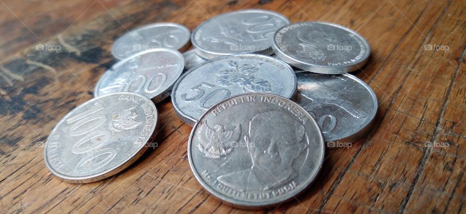 Rupiah coins on an ancient wooden table