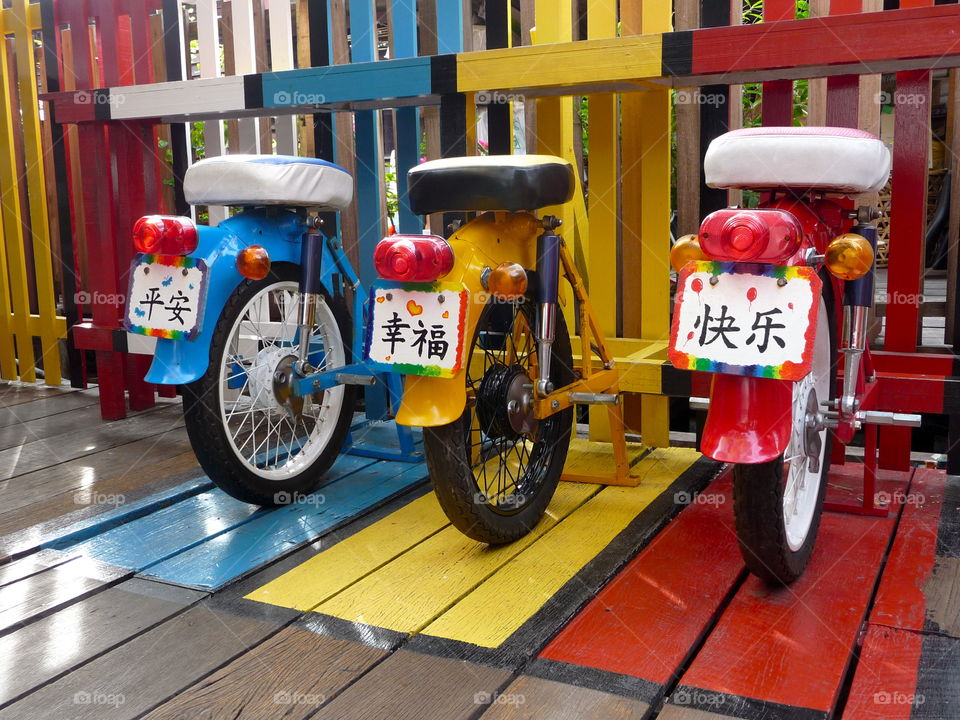 Colourful scooter. They make a wonderful place to sit and to enjoy - seen in a little fruit bar in Georgetown, Penang