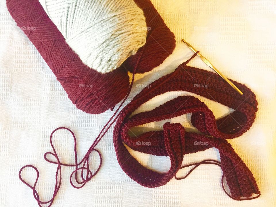 Crocheting with maroon and grey yarn