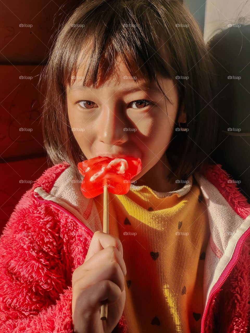 A little girl enjoying sweet candy lolipop