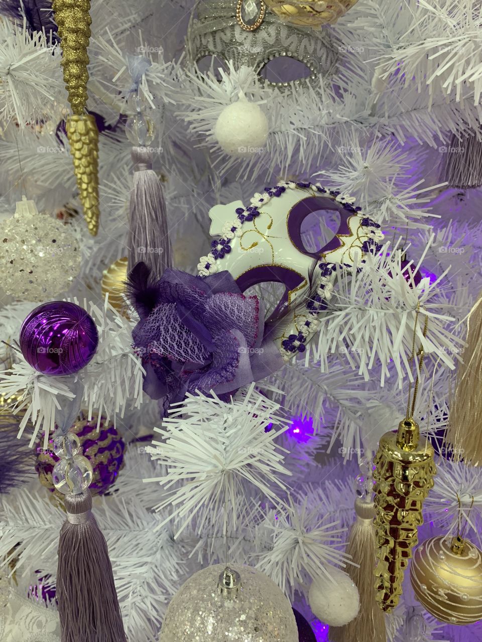Christmas decorations. white spruce decorated in purple and gold color. Celebrate all the holidays.