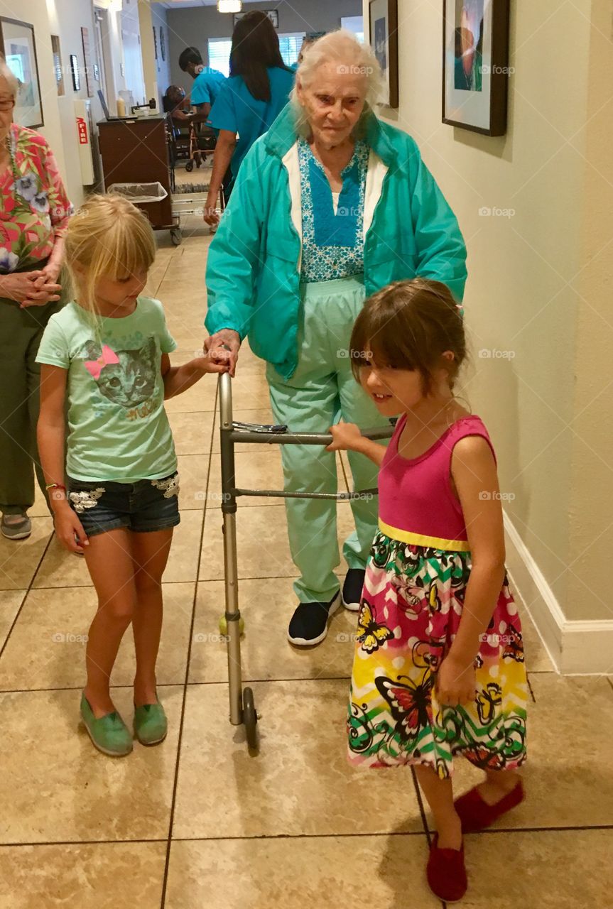 Granddaughter helping her sick grandmother to walk