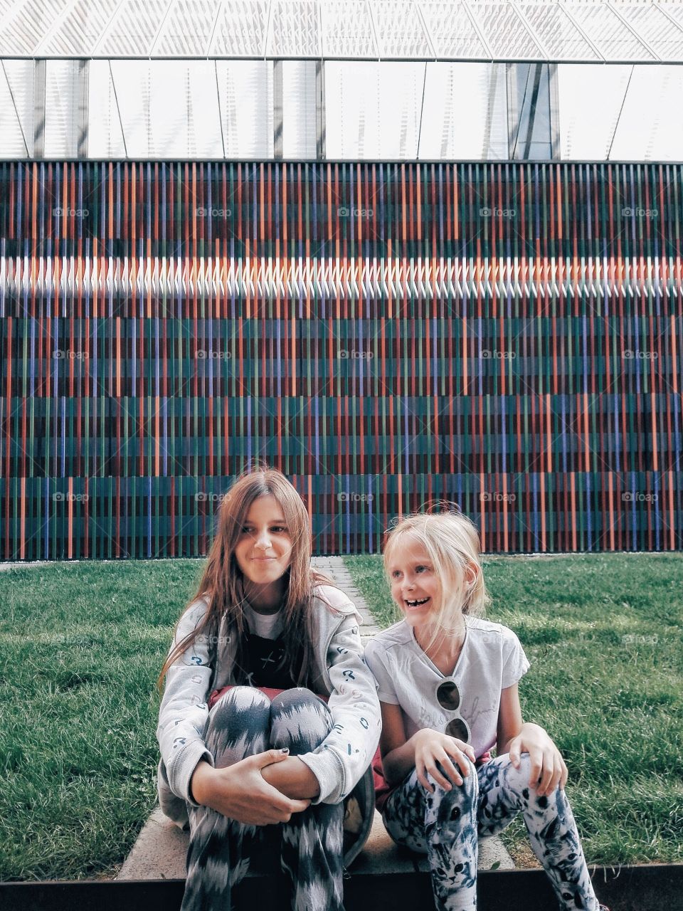 Siblings sitting in park