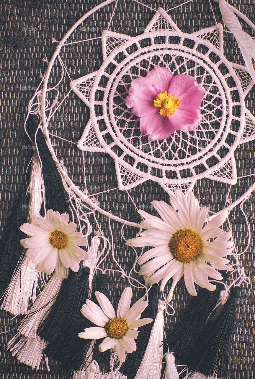 Dream catcher and flowers on the table