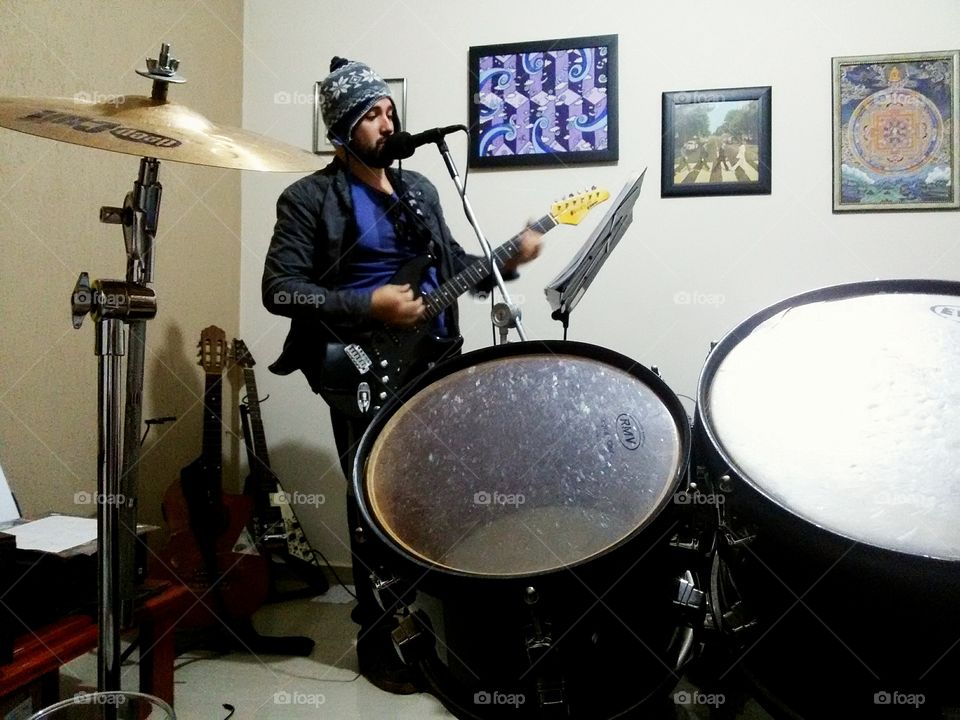 Portrait of a Man singing and playing guitar