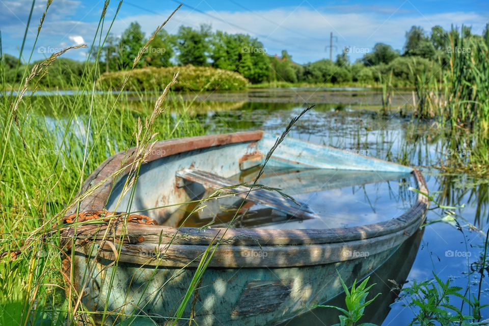 Old boat on a pond