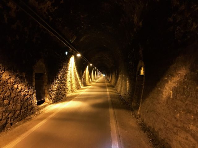 In the tunnel is illuminated with yellow light, creating a beautiful dark and light, very few people pass by.  mostly during the bike tour would pass it
