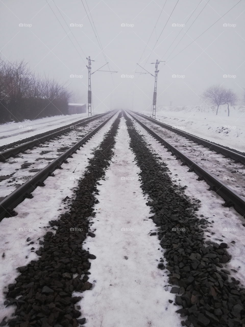 A picture of 2 rail line going far away