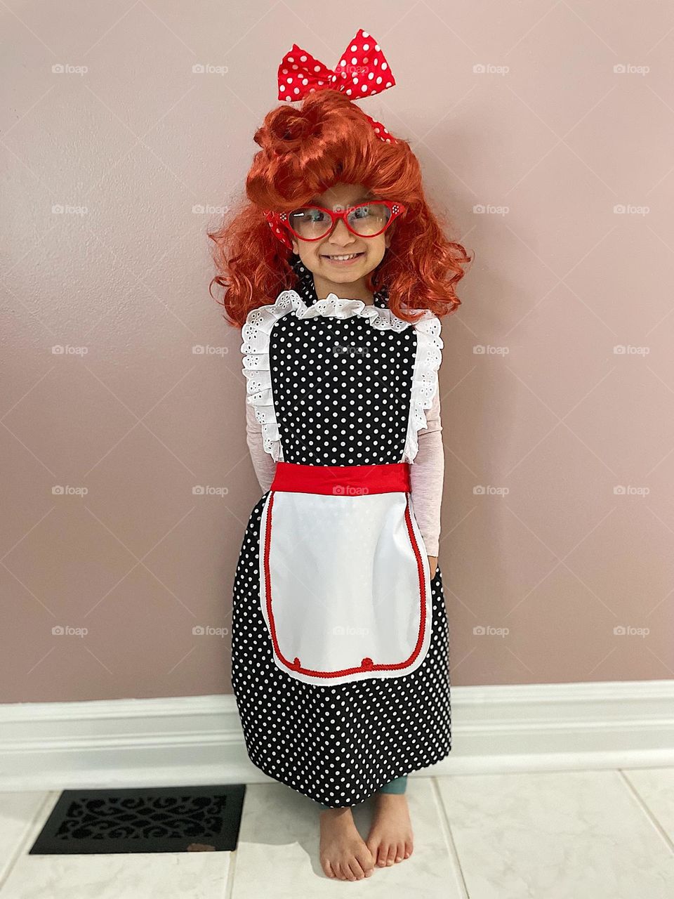 Toddler girl dresses up as I Love Lucy Lucille Ball, toddler girl dressed in costume, costumes for toddlers, funny toddler costumes, iconic costumes 