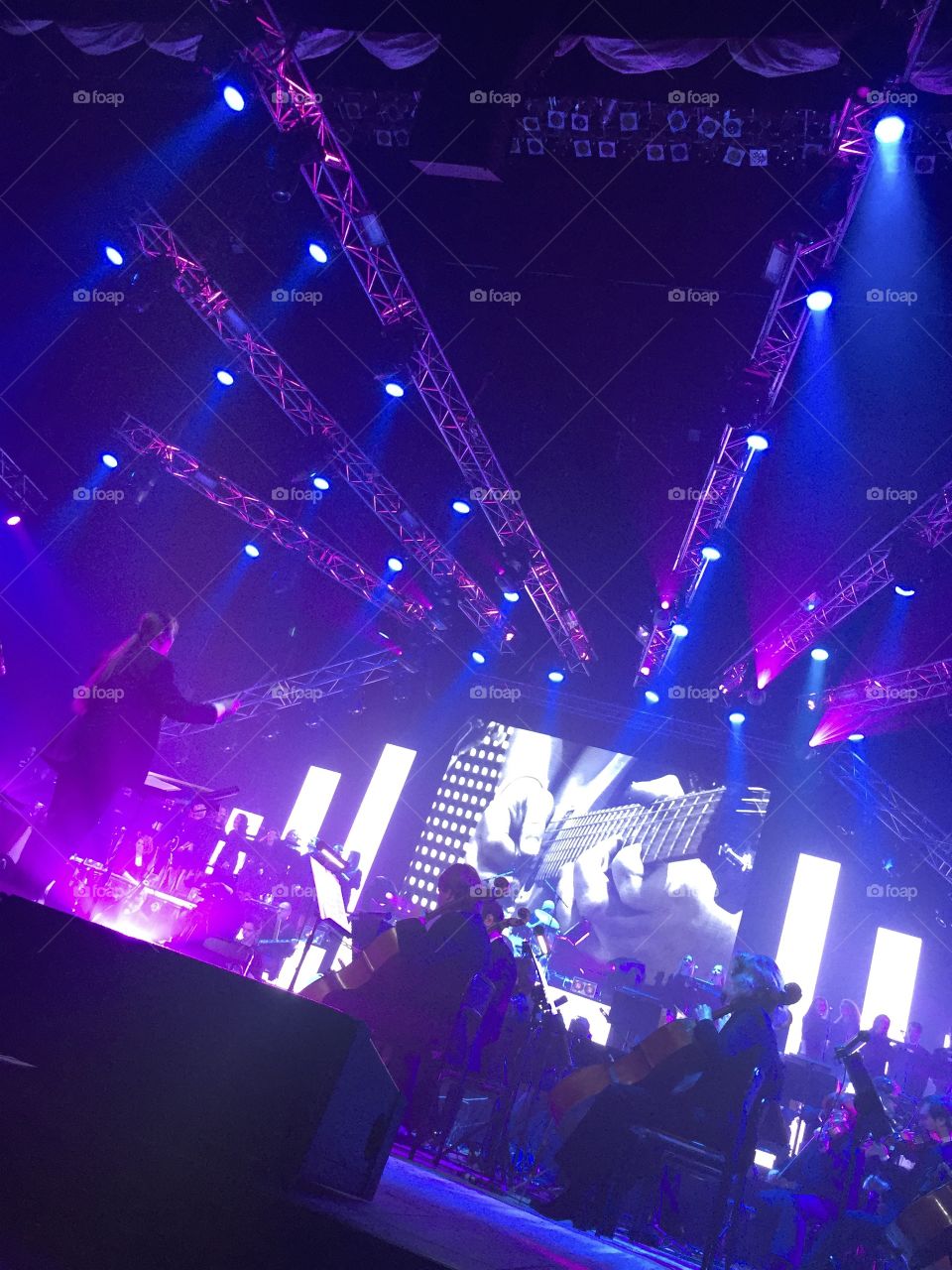 Symphonic orchestra concert on a stage illuminated 