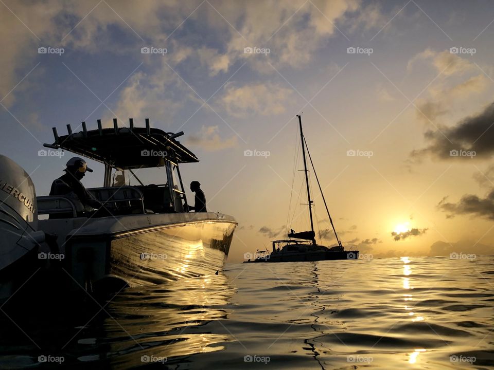 Sunset over the water reflecting in boat
