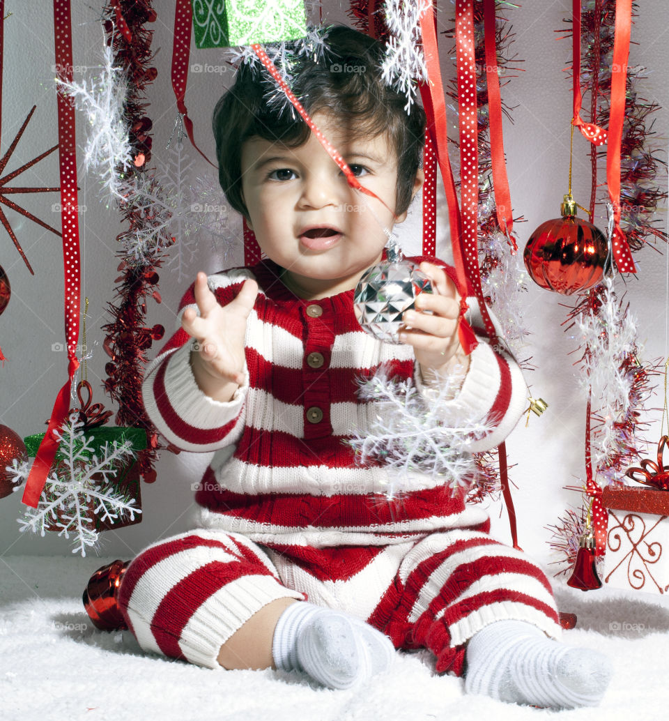 Baby holding Christmas ornament