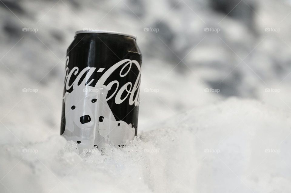 A coke with a background of ice