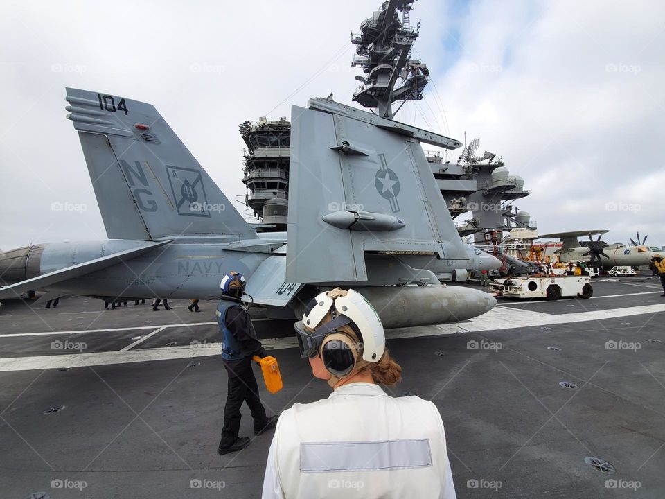 Flight ops on an aircraft carrier deck are very strenuous and dangerous and requires everyone to be aware of their surroundings