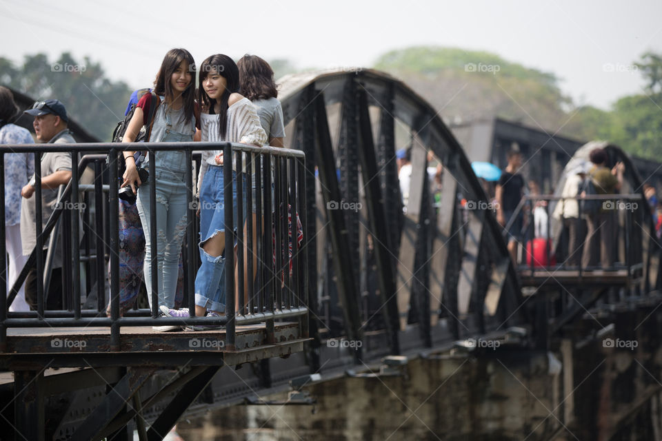 Young girl looking at camera in the railway bridge in Kanchanaburi Thailand 