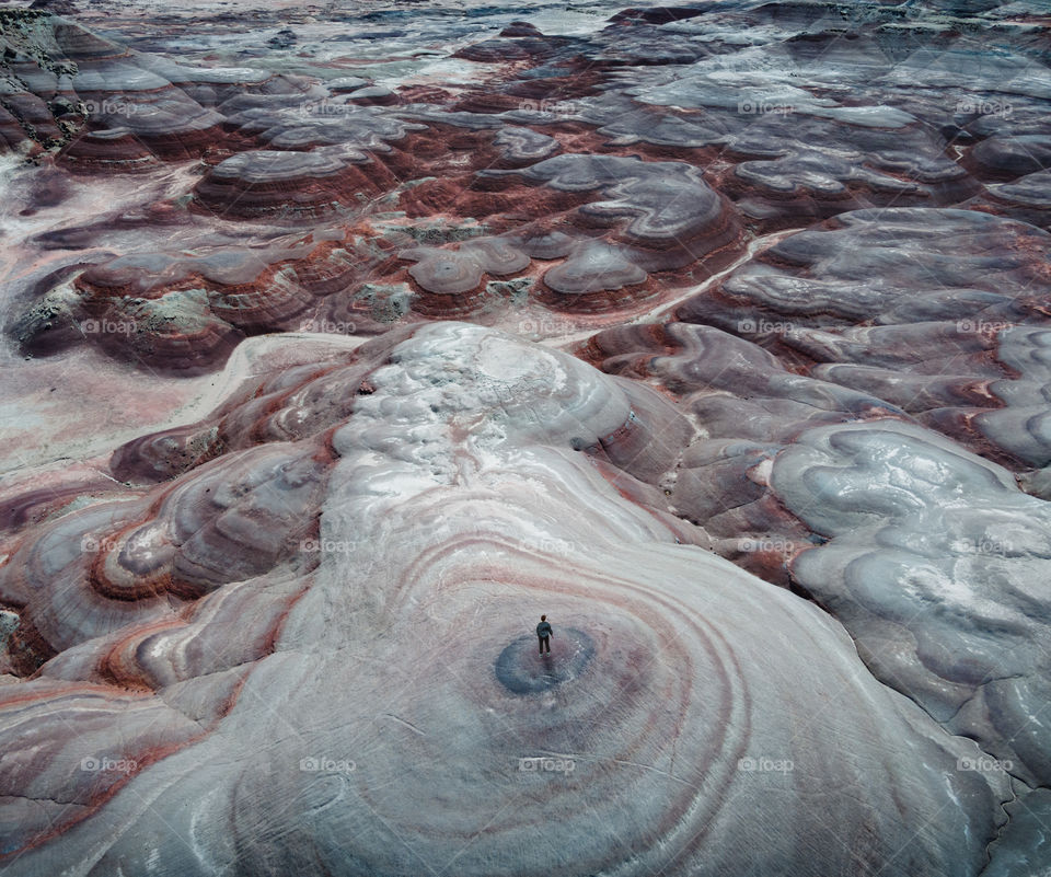 A lone man looks out on a weird Mars-like landscape in Utah.