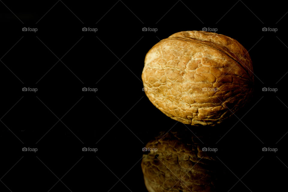 Walnuts in shell  on black surface