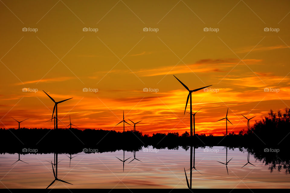 Sunset over wind turbines farm in Puck