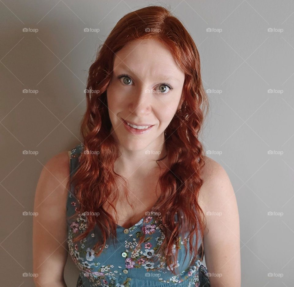 Portrait of a pale ginger with a dusty grey background