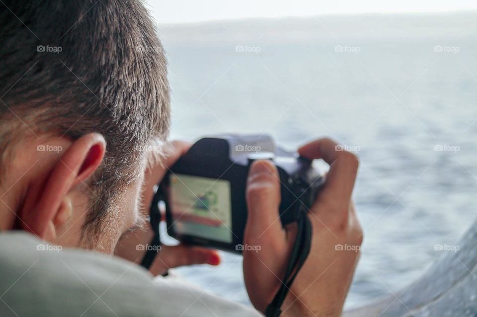 The guy takes a photo from the ship