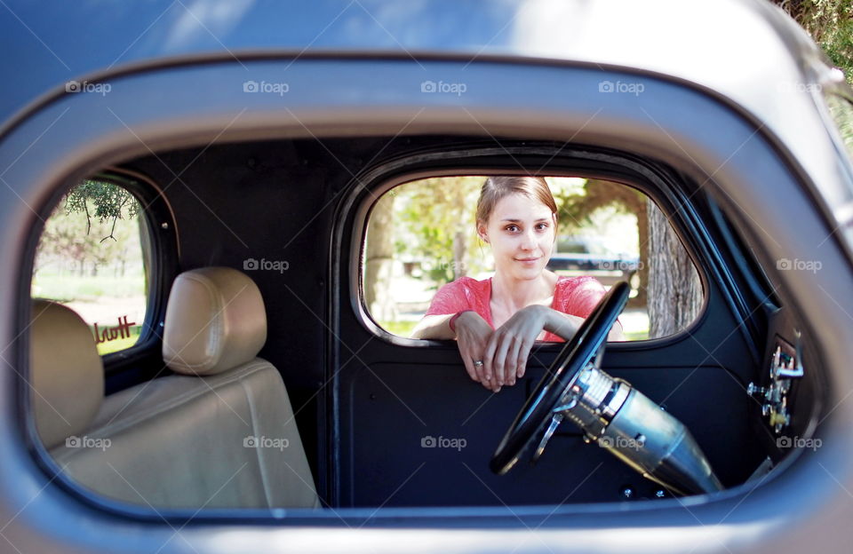 Portrait of a woman looking through car window