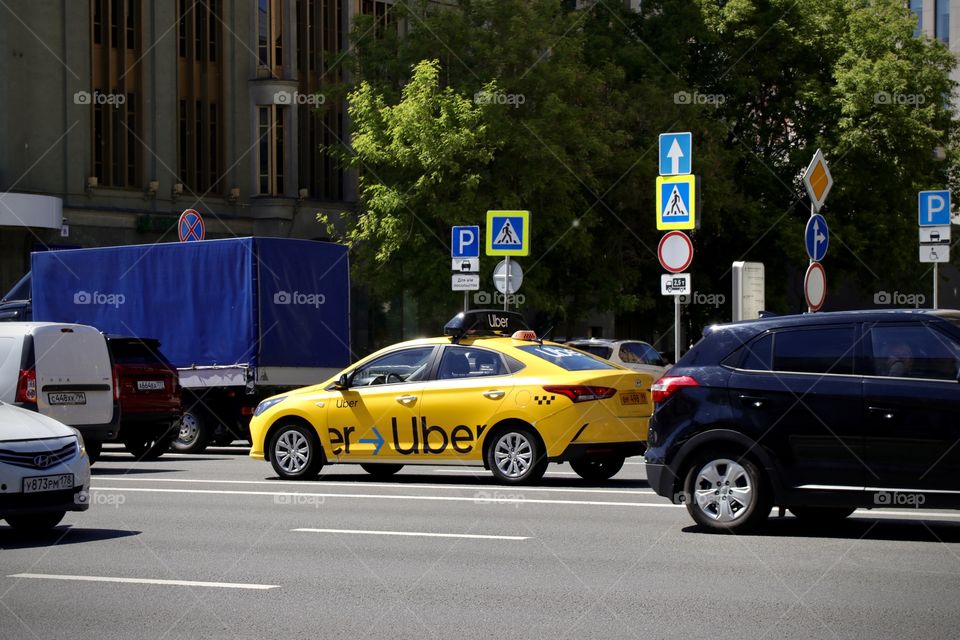 Yellow taxi Uber on the road 