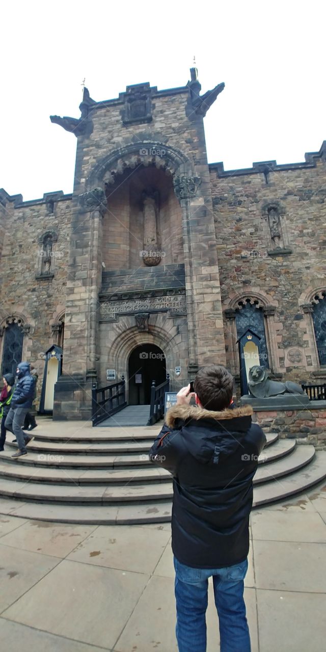 tourist taking shot of old building in winter