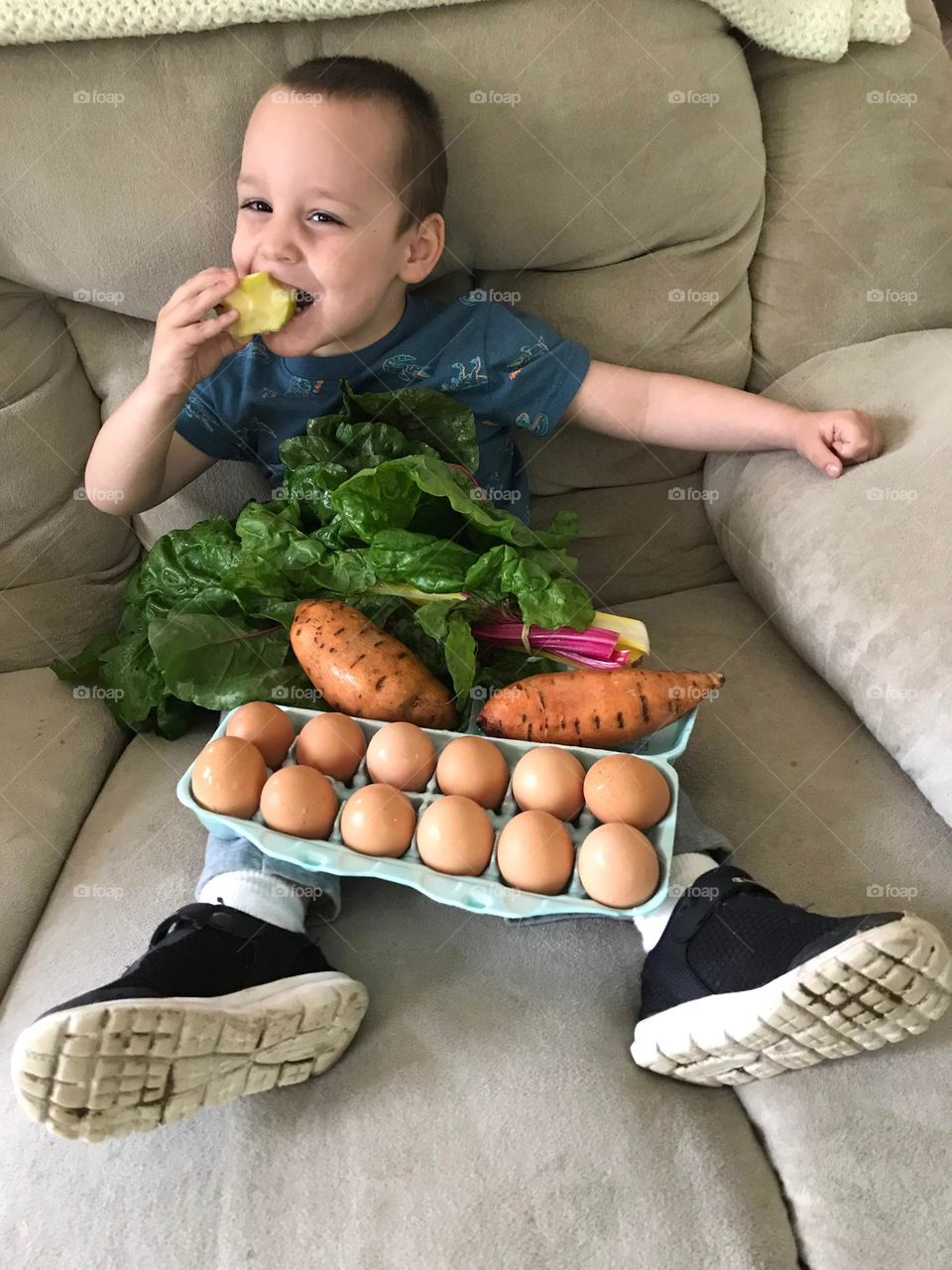 Child with eggs and vegetables after a trip to the farmers market