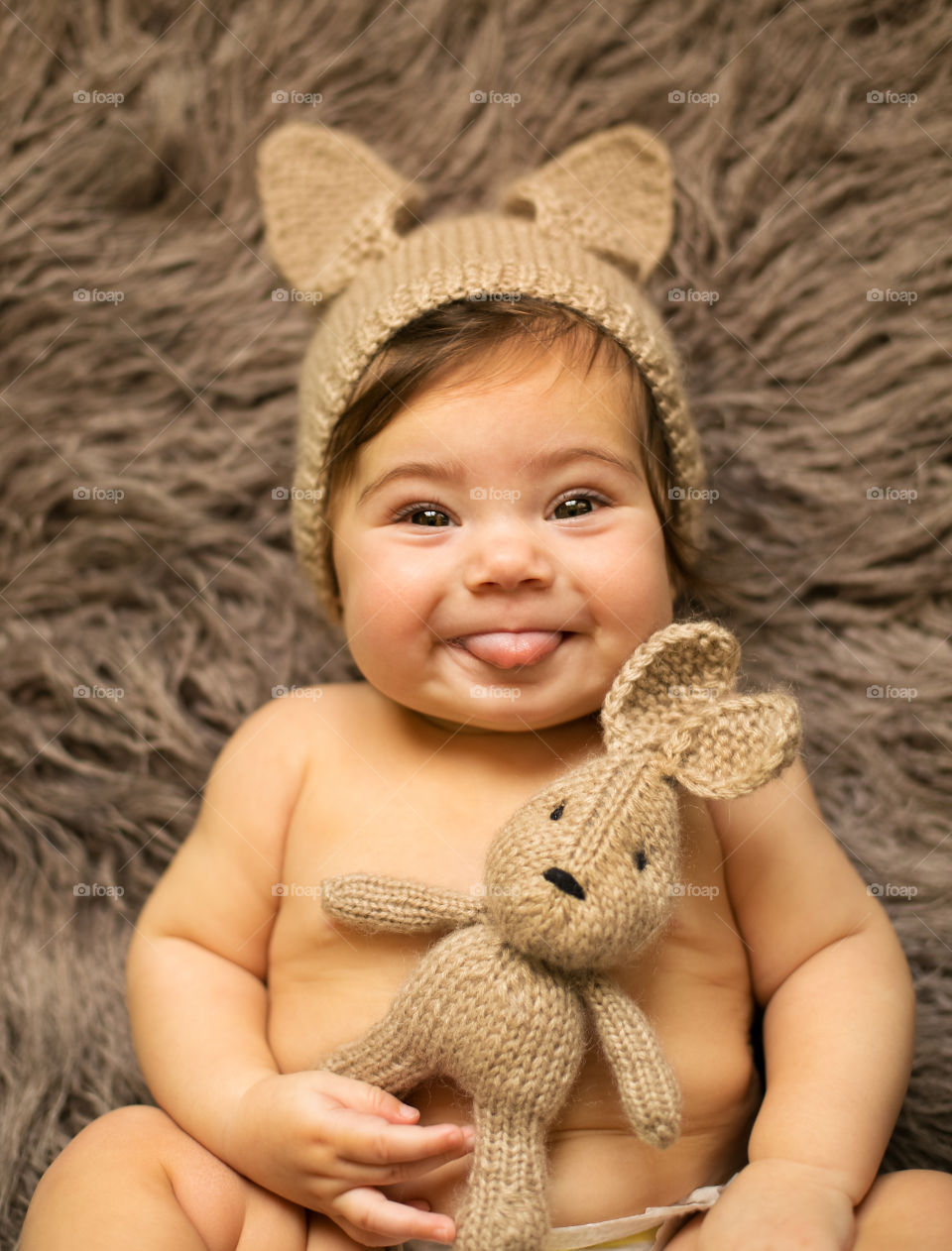 A baby holding woolen toy