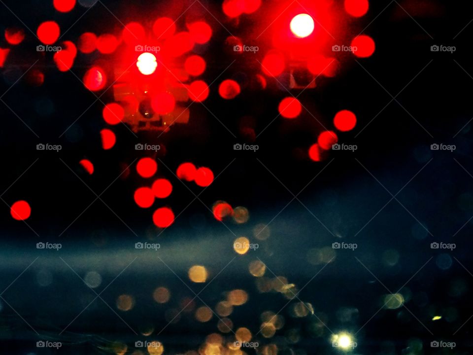 Red tra Lights blurred by the rain