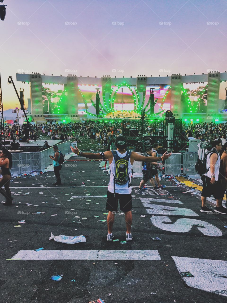 Man with arms open in the morning at EDC festival. 