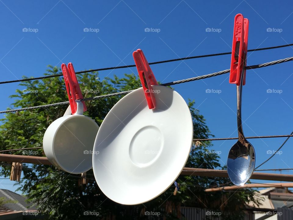 Solar power? Economical frugal dish drying, good for the environment too! Dishes hanging on s clothesline imagery